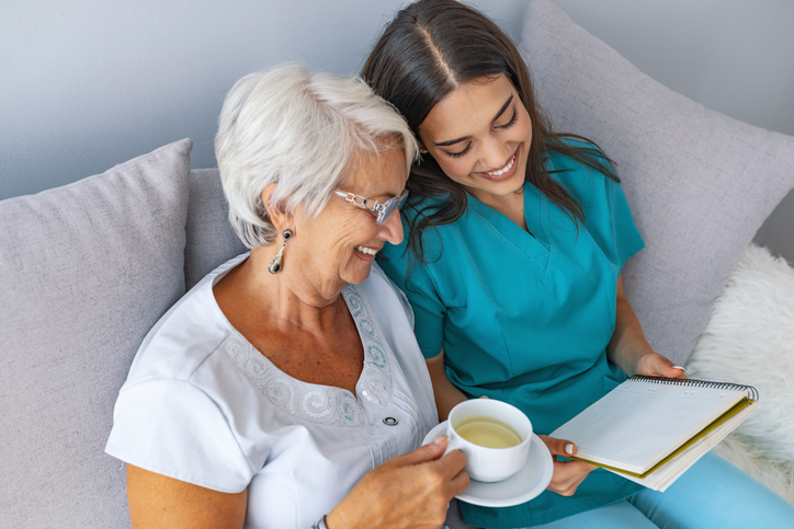 woman reading with caregiver