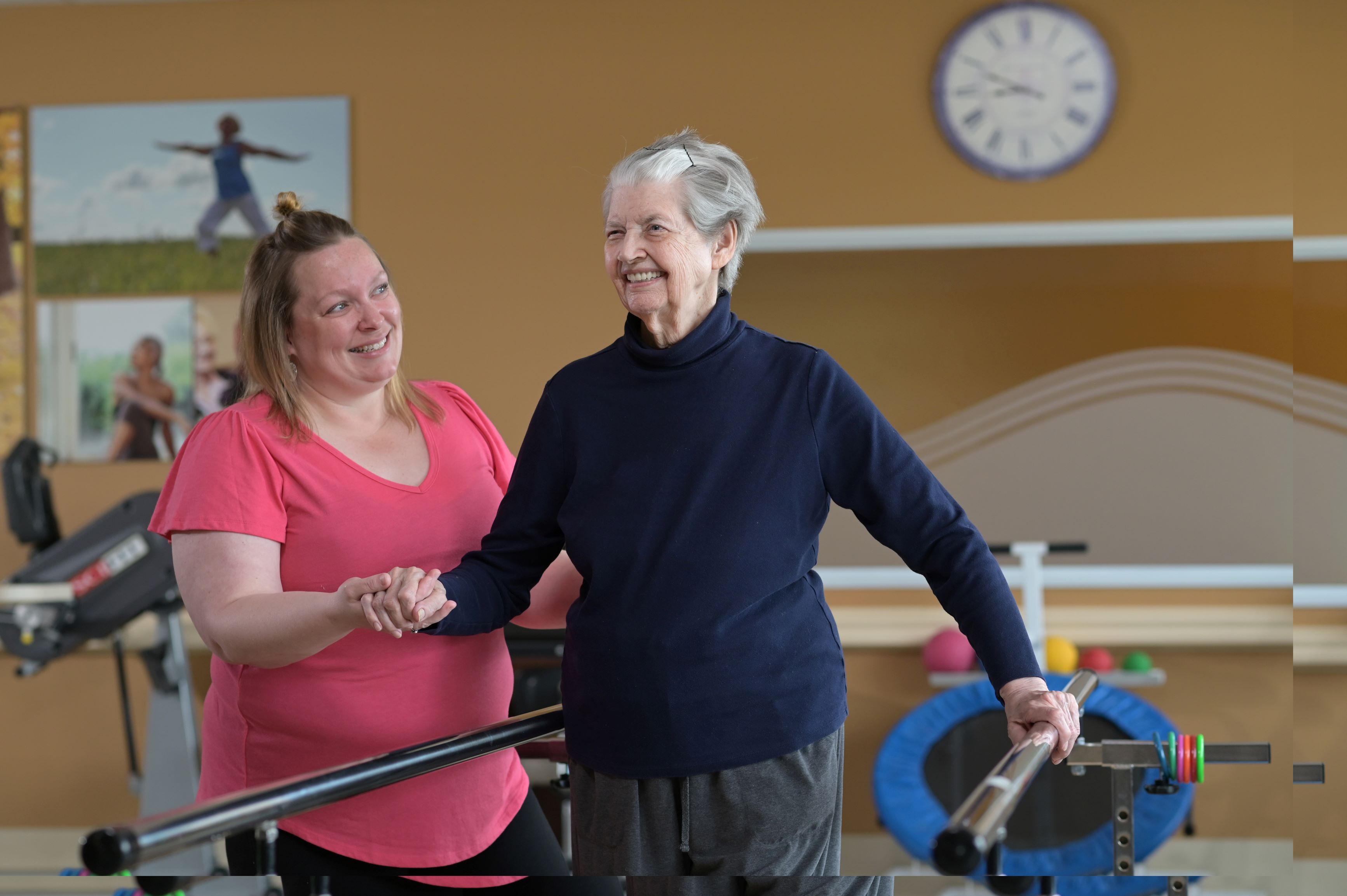 female senior working with physical therapist